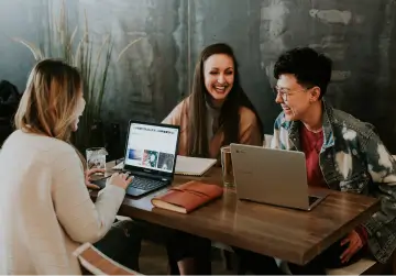 Three colleagues reviewing the Chefgaa platform on laptops