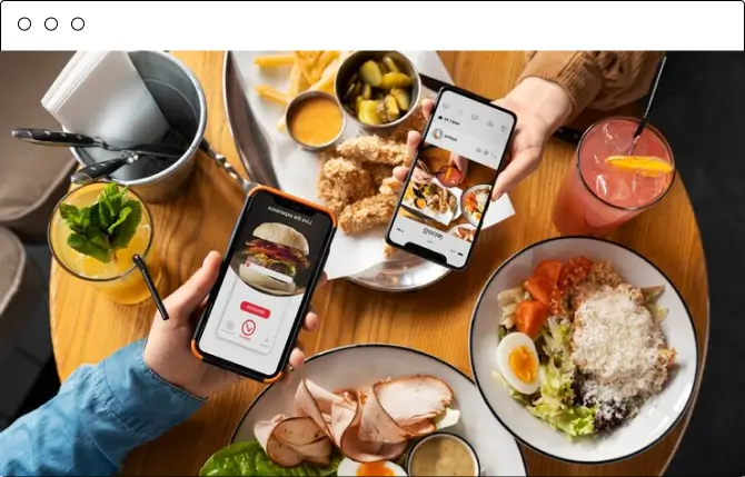 Two phones showing a food order above a table of takeout dishes