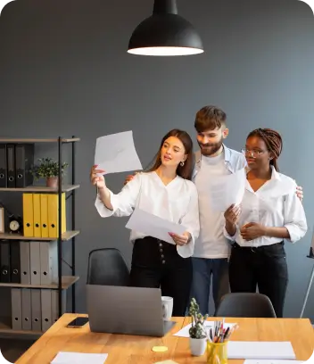 Restaurant management team reviewing reports in the office
