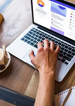 Restaurant staff using a laptop to manage orders