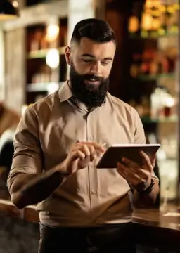 Restaurant staff using a tablet to manage orders